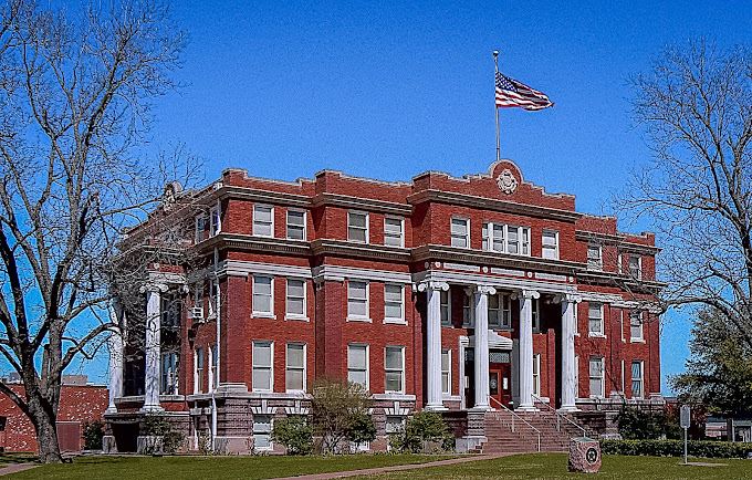 A building with a flag on top

Description automatically generated